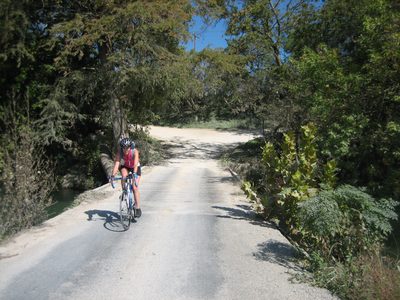 Kate crosses a bridge at the bottom of a big downhill /...