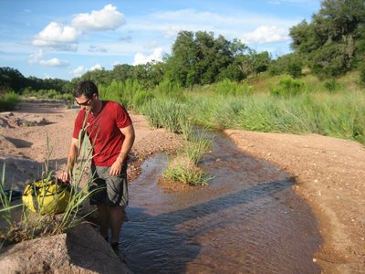 Jay playing in the creek after some ants attacked his ankles.