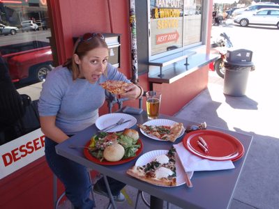 Catherine digs in to lunch - cheese pizza in hand,...