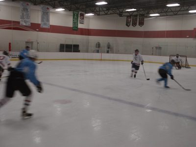 Skating in on goal with the puck.