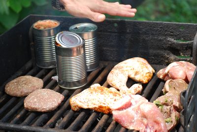 Lunch meats and beans cooking on the stove.
