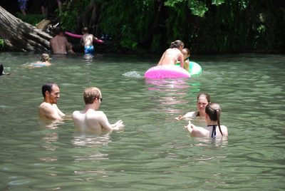 Jose, Matt, Kerry, and Kelly squirt water at each other.