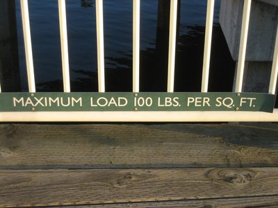 A sign on a waterfront pier.
