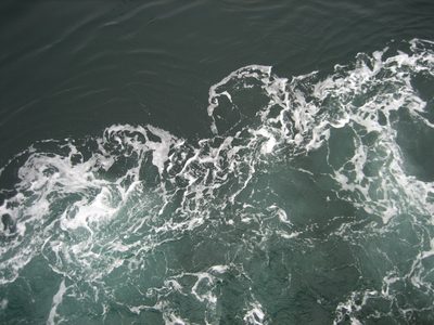 Desktop background of water churning near the hull of the ferry.