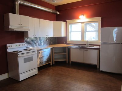 Kitchen.  The owners are debating painting the red walls...