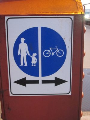 Bicycles to the right, older gentlemen leading reluctant...