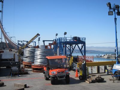 Spools of wire wait their turn.  On the right, the blue...