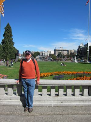 Dad stands outside the BC Parliament Building, with the...