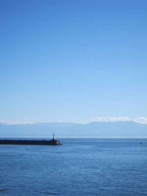 A final shot of a lighthouse in Canada and mountains in America.