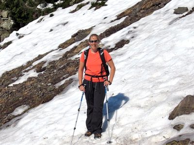 Making my way across a snowy patch.  My hiking poles and...