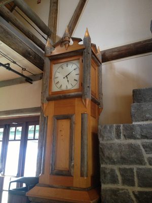 Giant grandfather clock made with log accents.