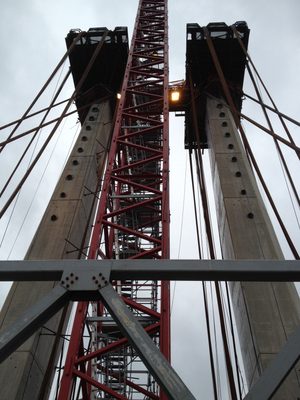 Looking up at the tower crane and the towers.  Draped...