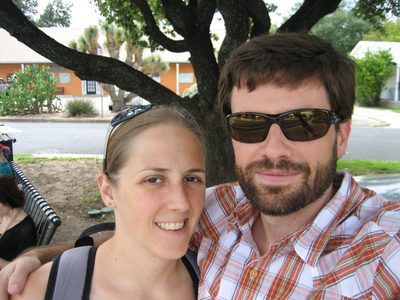 Catherine and Jay wait at the bus stop to go downtown. ...