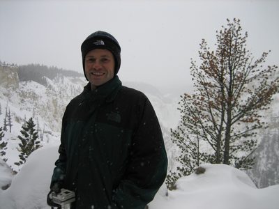 Jay tries to stay warm in front of the slighty-snowed-out scenery