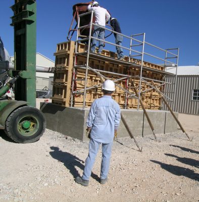 Tim watches while Catherine and Jim unload the bucket.