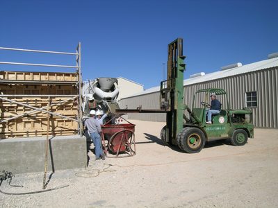 Lewis acts like a manager while Tim loads the bucket;...