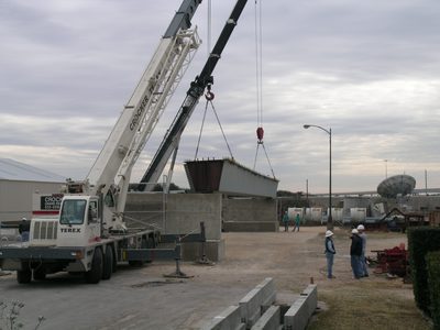 The first girder is lowered into place (60,000lbs of...
