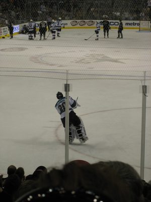 The goalies played catch while a fight ensued on the boards.
