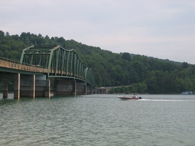 A motorboat passes under the bridge.