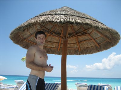 Jay standing at the pool with the beach in the background.