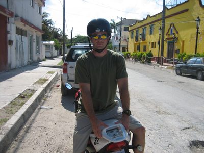 Jay back on the scooter.  The helmet should be...