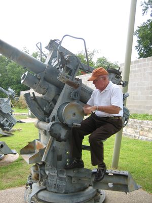 Dad playing with a big gun.