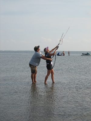 Cliff helps Jules fly the kite and/or not get dragged away.