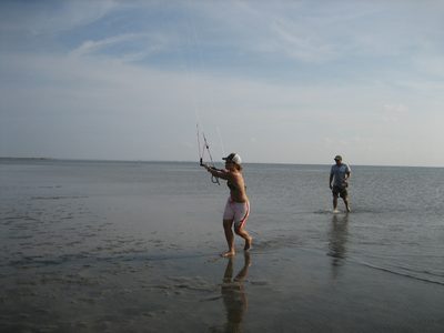 Lana flies the kite back to the cars, so as to keep it...