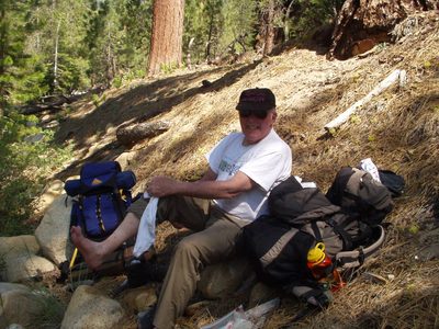 Dad drying off his feet after our river ford.