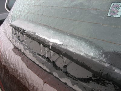 The back windshield wiper, firmly attached to the windshield.