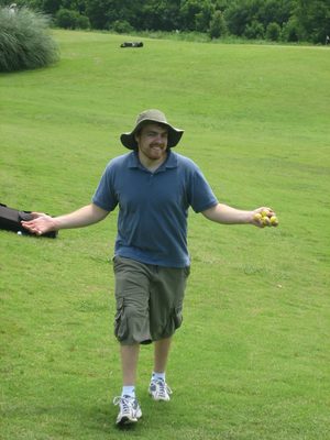 Thomas collects himself some range balls.