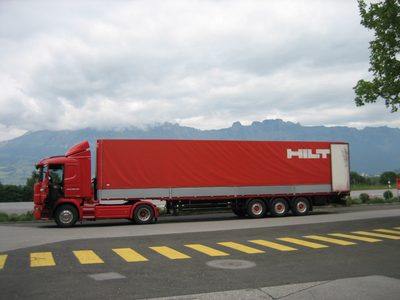 A Hilti truck parked in front of the mountains near the...