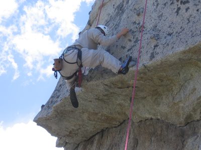 John getting over the roof on Over Easy (5.7) on Middle Spire.