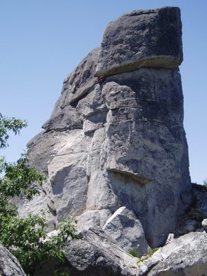Colin sitting at the top of the first pitch of a 5.10a...