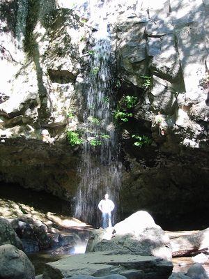 Behind a waterfall.