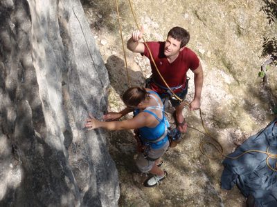Jay gives Catherine some beta (and a belay) as she...
