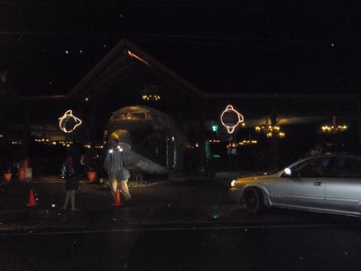 The bar (plane) as seen from the street at night.