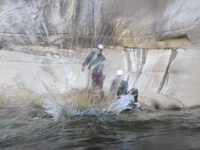 Joel tosses his bag in the water.