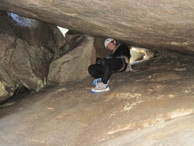 Colin climbs through a cave-like tunnel under a giant...