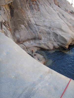 John dries off and rests at the bottom of the 150 foot waterfall.