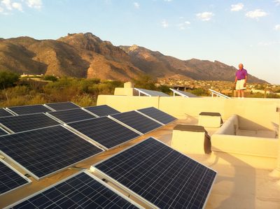 Dad on the roof with his 8 kilowatt solar panel system