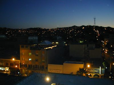 View west from roof deck.  Lower building with roof...