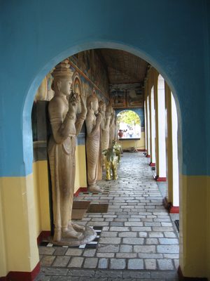 Beautiful carved bodhisattvas lining a shrine next to...