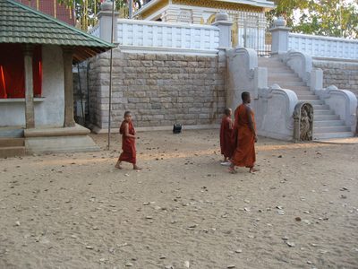 A monk leads two monks-in-training.