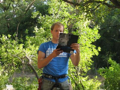 John studying the guidebook, and with some concern,...