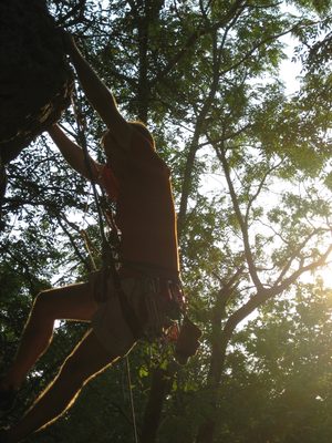 John hanging from the edge of a big rock.