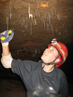 Catherine inspecting a helictite, a stalagtite that...