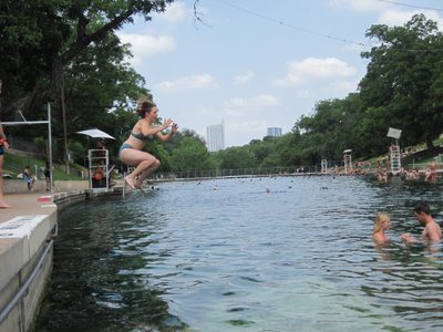 Catherine jumping in Barton Springs Pool.
