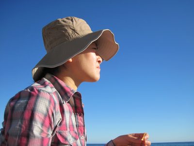 Monica staring off at the sun, still low in the sky...