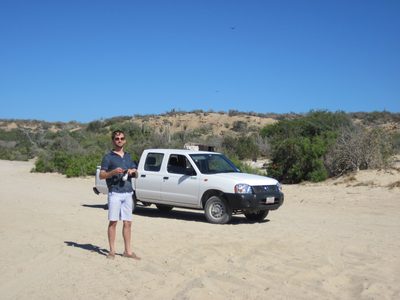 Jon, standing on the Frailes beach, with our truck in...